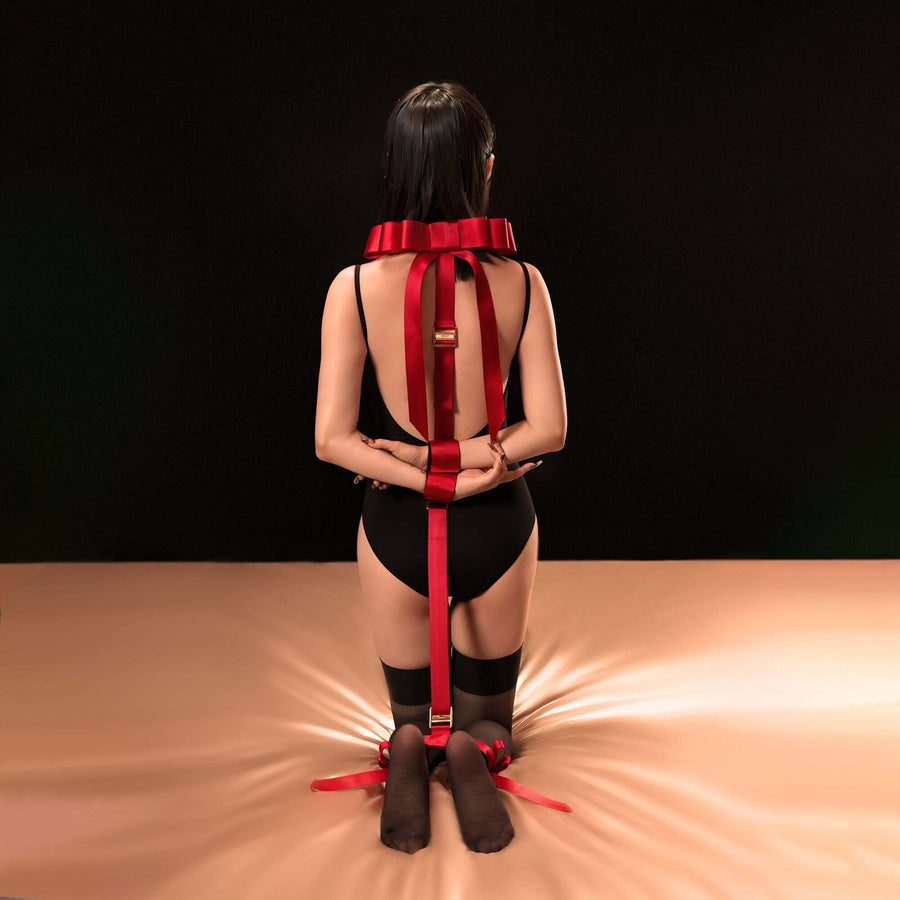 Model showcasing Bowknot Hogtie Portable Bondage Gear in bold red, featuring elegant bow-knot details, set on a neutral background.