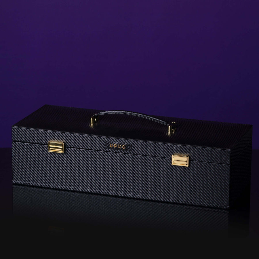 Luxury black leather bondage tools case with gold accents and handle, perfect for storing BDSM accessories.